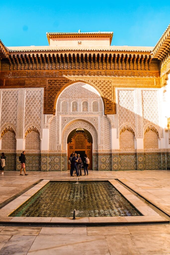 Explore the stunning architecture of Ben Youssef Madrasa's courtyard in Marrakech, Morocco.