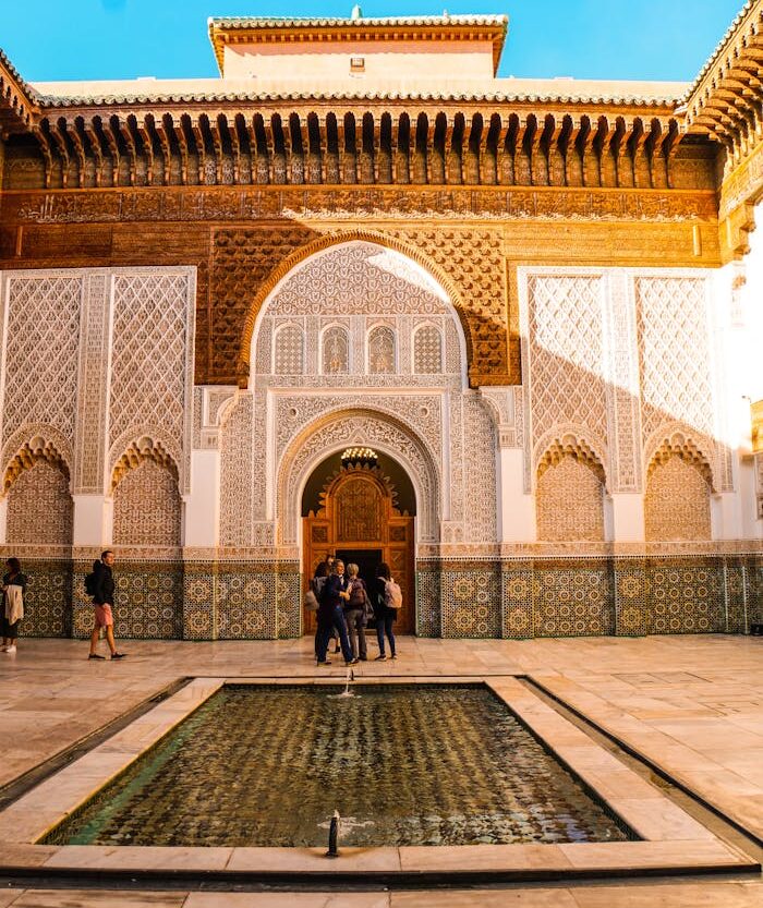 Explore the stunning architecture of Ben Youssef Madrasa's courtyard in Marrakech, Morocco.