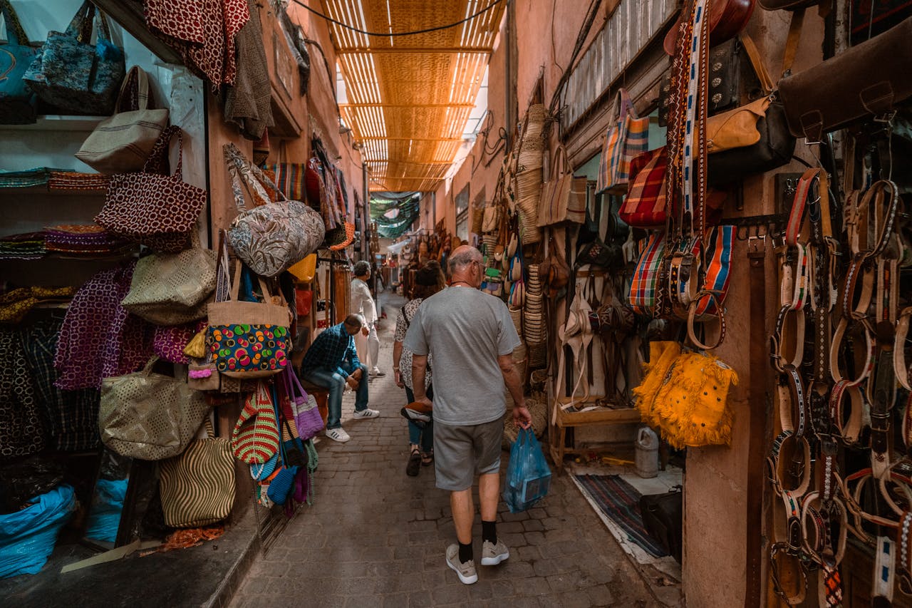 Home Explore the bustling souk in Marrakech with colorful textiles and local crafts on display.